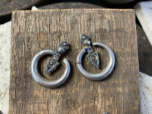 Large pair of tribal silver earrings called Bent Arrow. Worn pushed sideways through the ear by Yao women. High grade silver, they can only be worn with an extended piercing