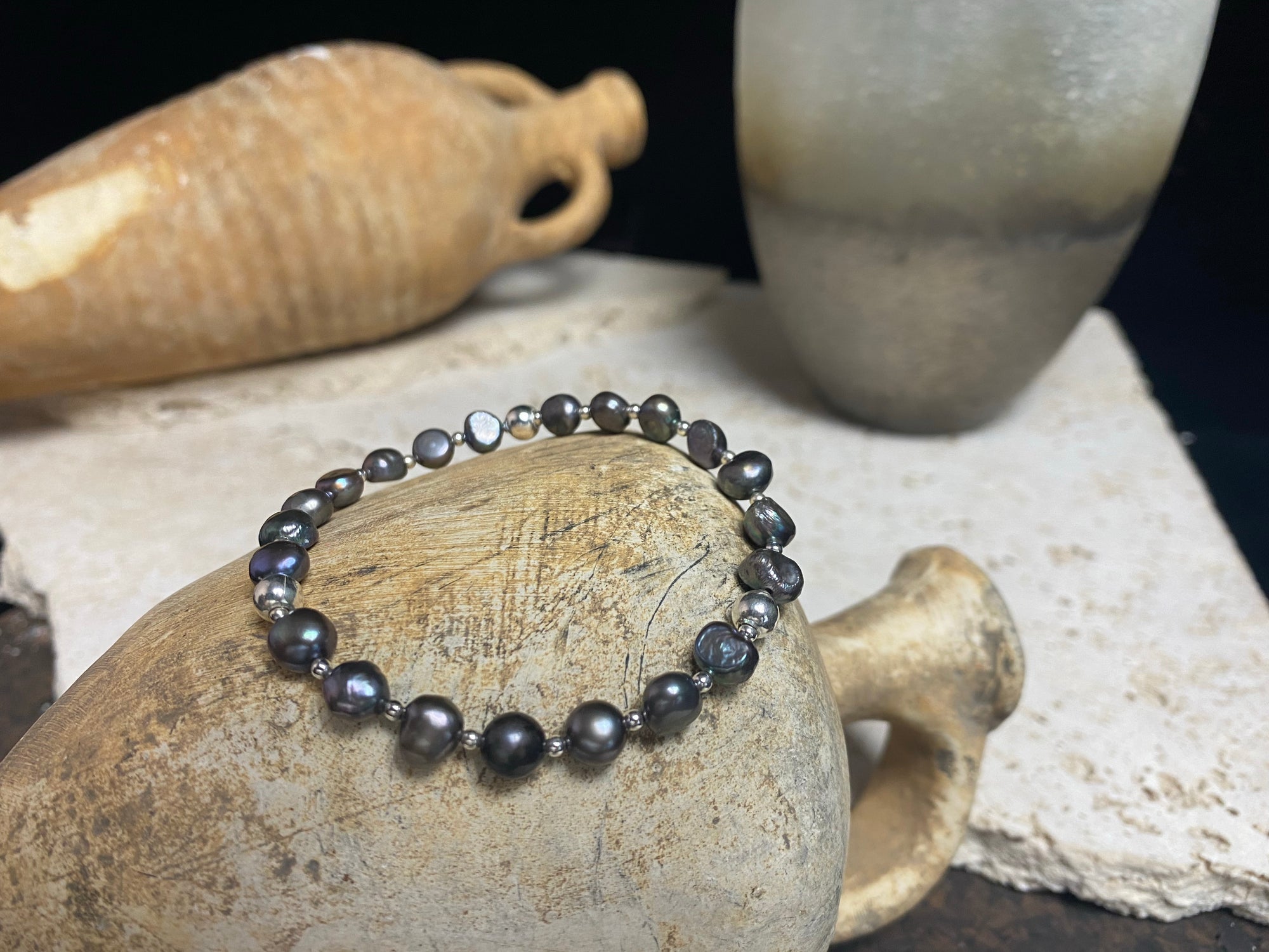 Grey black freshwater pearl bracelet with sterling silver bead detailing. Elasticised stringing for a seamless look. Length 19 cm
