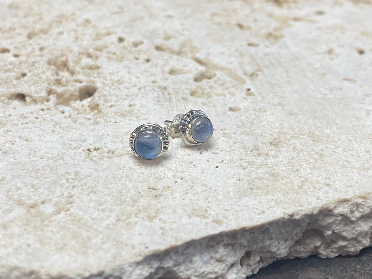 Simple and elegant, these small rainbow moonstone earring studs are hand made from sterling silver and set with natural rainbow moonstone cabochon stones