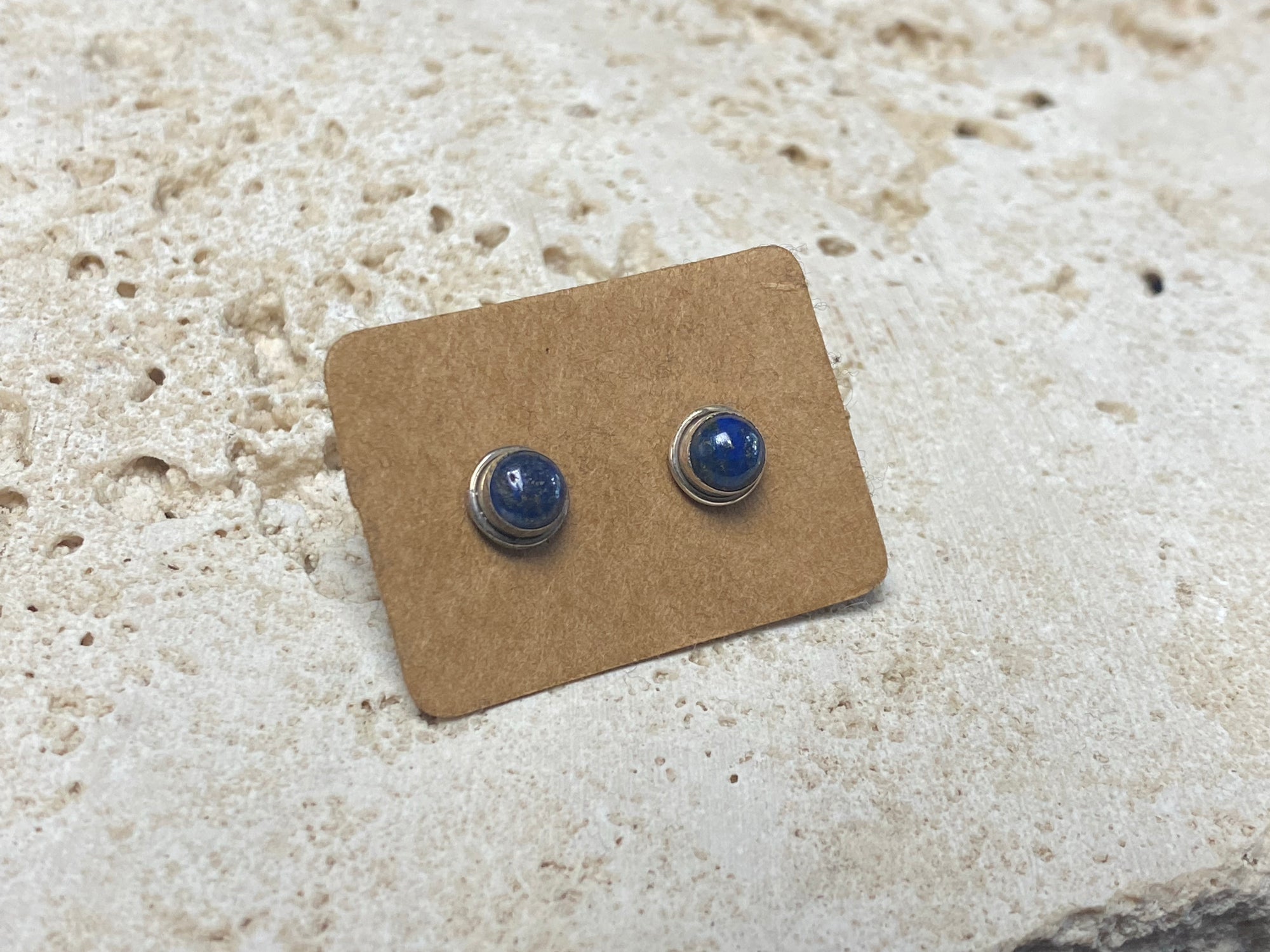 Simple and elegant, these small lapis lazuli earring studs are hand made from sterling silver and set with lapis cabochons