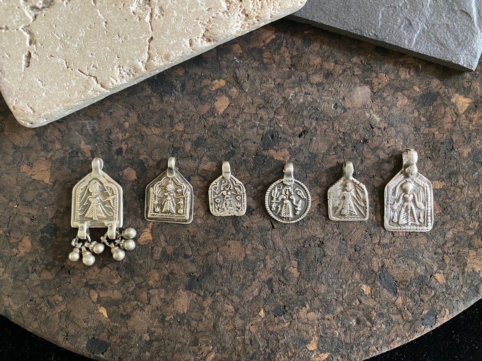 Antique silver amulets represent the Hindu goddess Kansari, goddess of the harvest and of fertility. These small pendants are traditionally worn for good luck, to increase fertility and to bring all good things to you and your home. These pendants date from the early 19th - early 20th century.  Measurements: all vary between 1.4 and 1.8 cm in width
