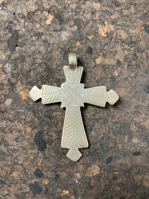 Early 20th century Ethiopian silver cross, most likely cut from a Marie Therese Thaler. Silver, with a simple engraved decoration on each side and light wear at the head of the bail,  total height including bail 7.5 cm (3")