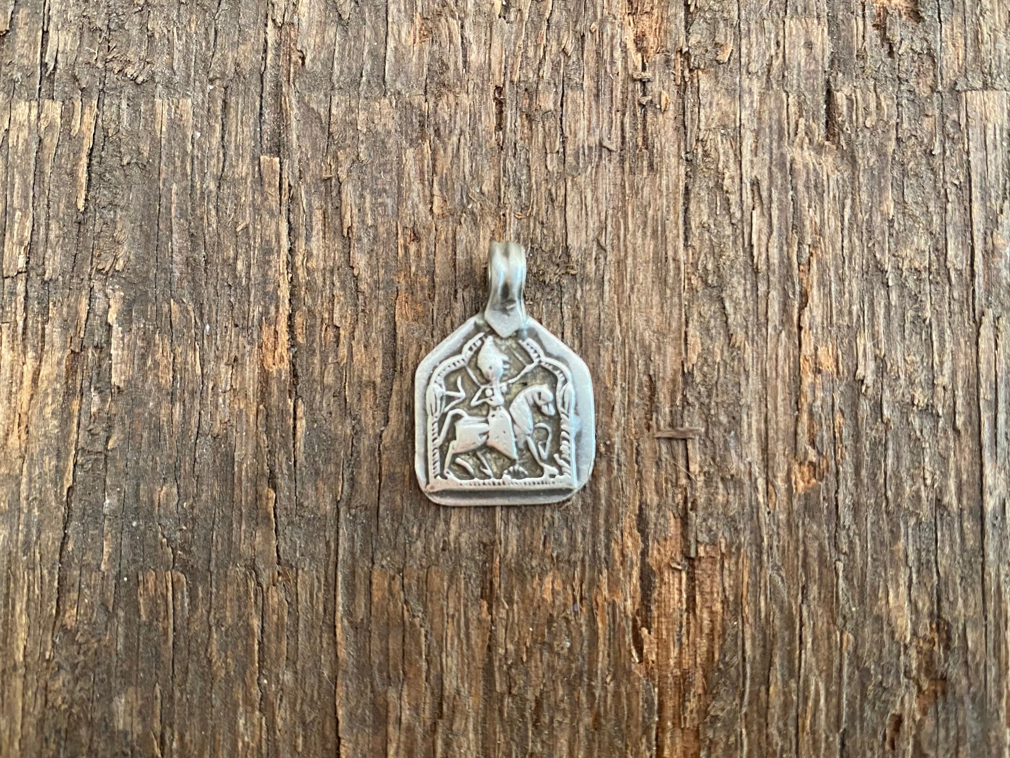 Antique silver amulets that represent Baba Ramdev (Ramdevshi), a legendary Rajput warrior who went about doing deeds of goodness and valour. These small pendants are traditionally worn for protection and good luck and date from the early 19th - early 20th century.  Measurements: all vary between 1.5 and 1.7 cm in width