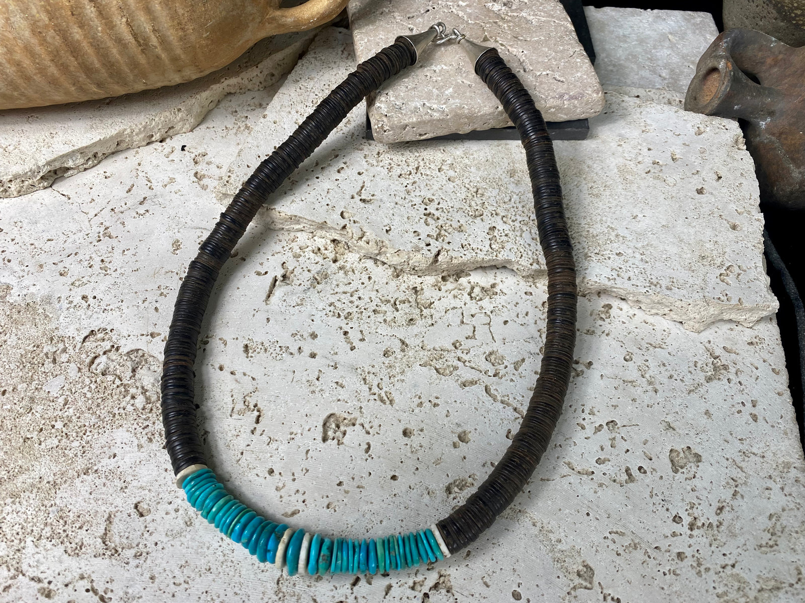 Statement necklace with an African vibe. Made from vintage wood heshi beads and Arizona turquoise, highlighted with vintage ostrich eggshell beads. The necklace is finished with handmade silver cone ends and a generous hook clasp. length 57 cm