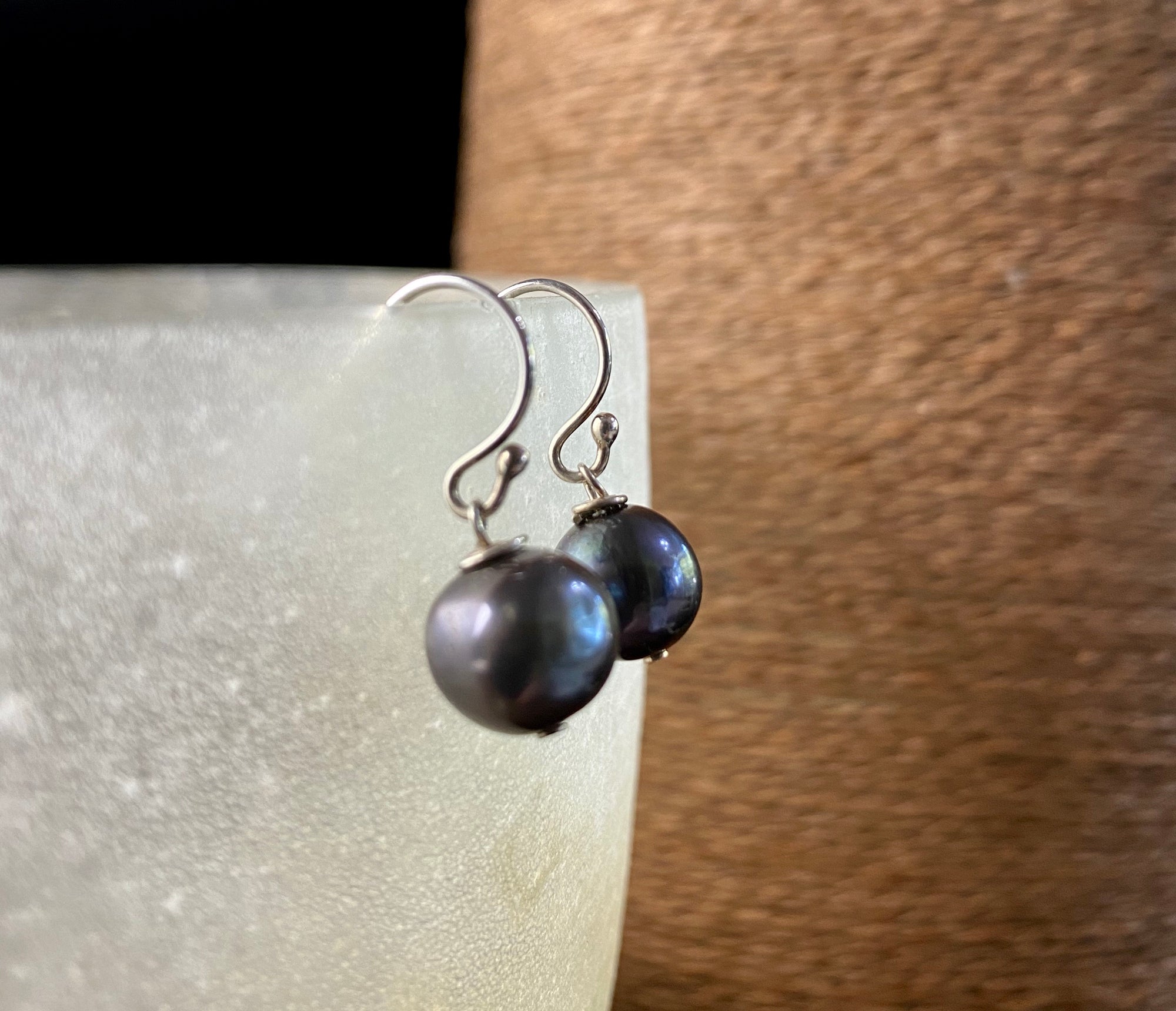 Cultured round black pearl earrings featuring high quality black Burmese pearls 7 mm in diameter and sterling silver hooks