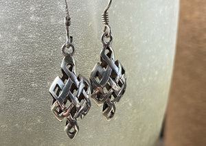 Sterling silver endless knot earrings featuring a 3 dimensional cutout endless knot