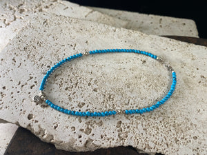Beach boho anklets featuring turquoise-look dyed howlite and sterling silver charms. Sterling silver clasps and detailing. Designed to sit gracefully around the foot rather than tight to the ankle. Select from three sizes and two styles