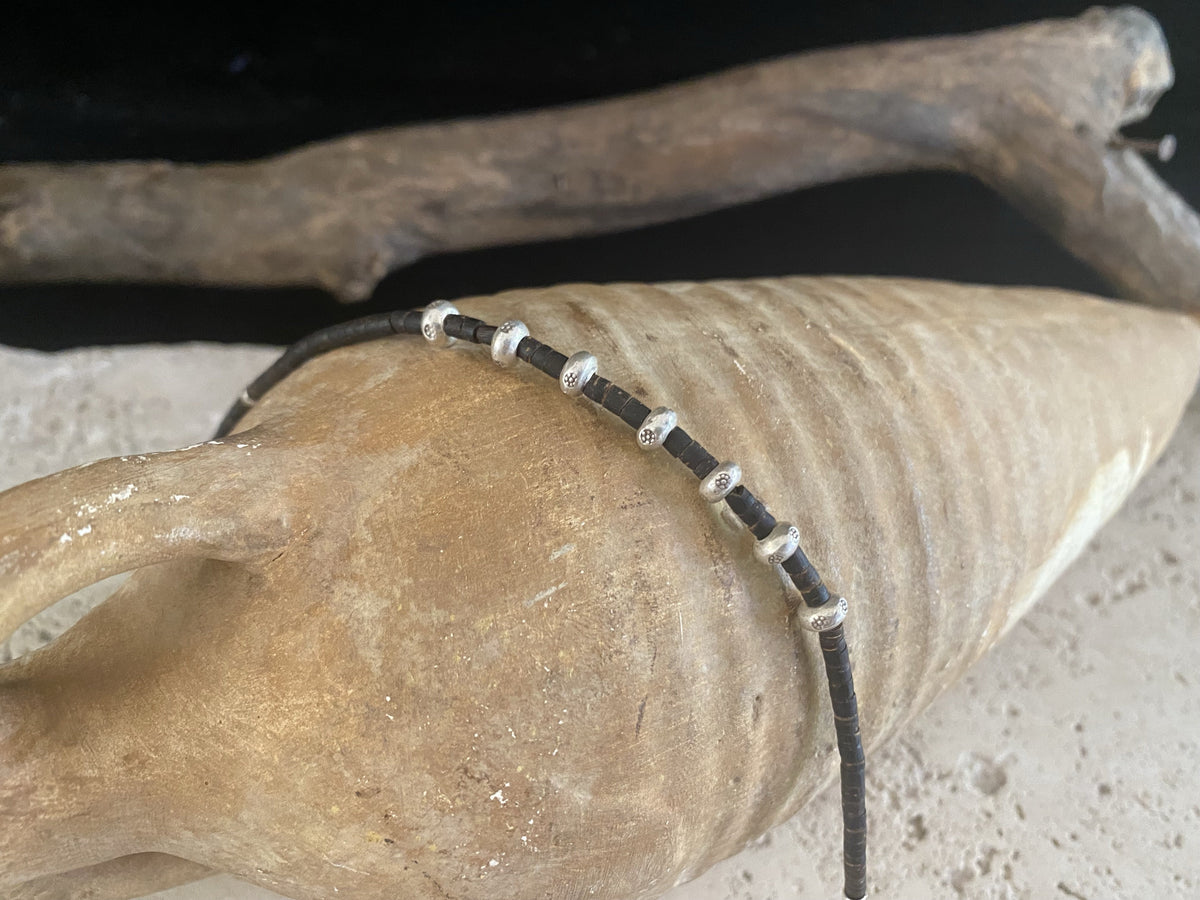 Coconut wood and silver bracelet. Suitable for men or women, our signature bracelet is made from enriched cocnut wood and 95% silver beads. Select from different lengths.