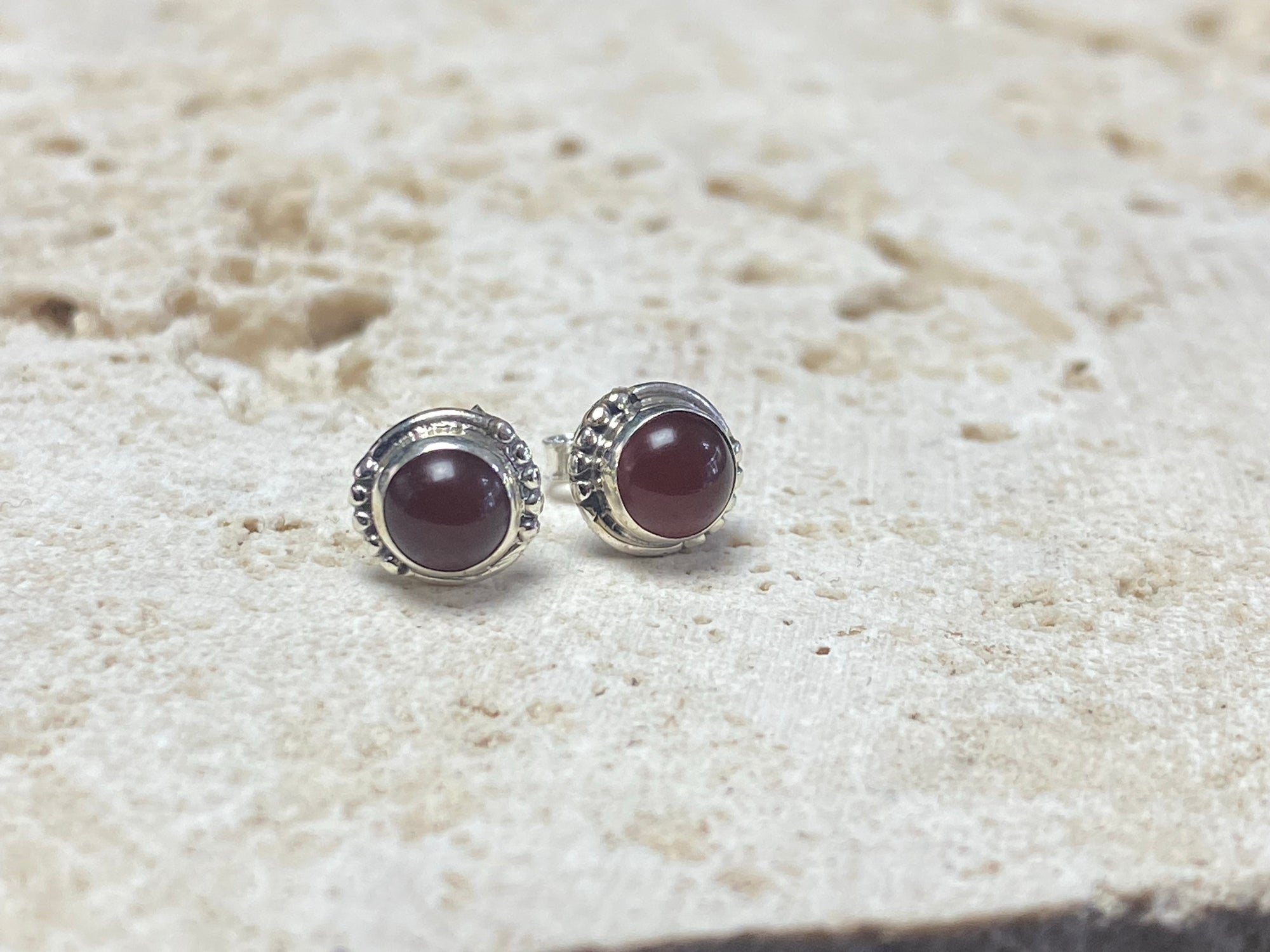 Simple and elegant, these small carnelian earring studs are hand made from sterling silver and set with natural carnelian cabochon stones