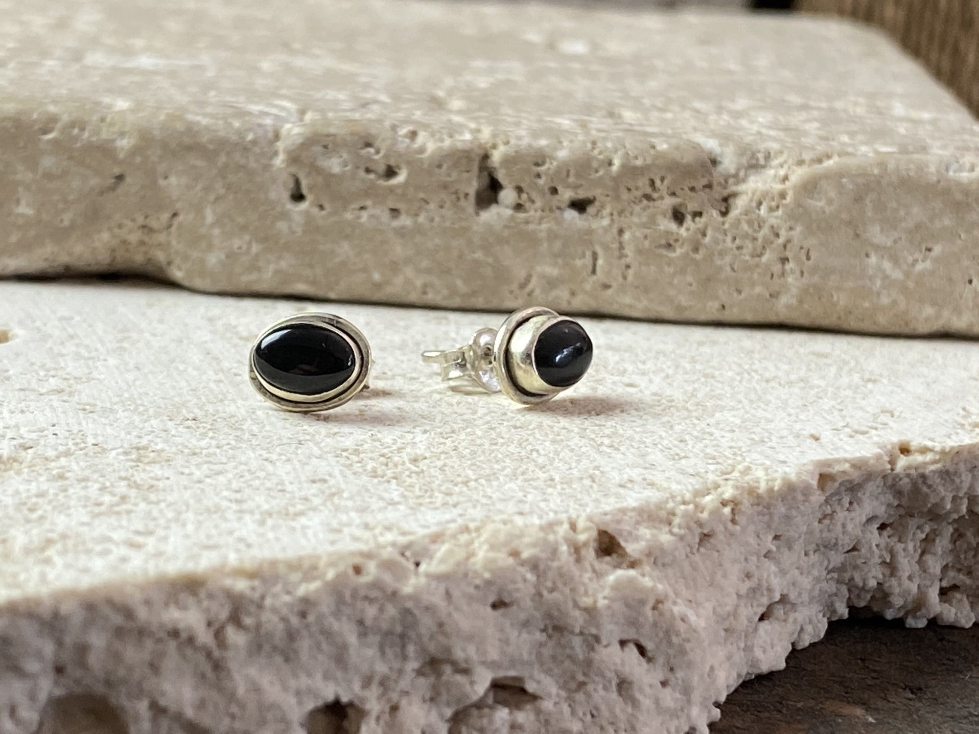 Simple and elegant, these small black onyx earring studs are hand made from sterling silver and set with onyx cabochons