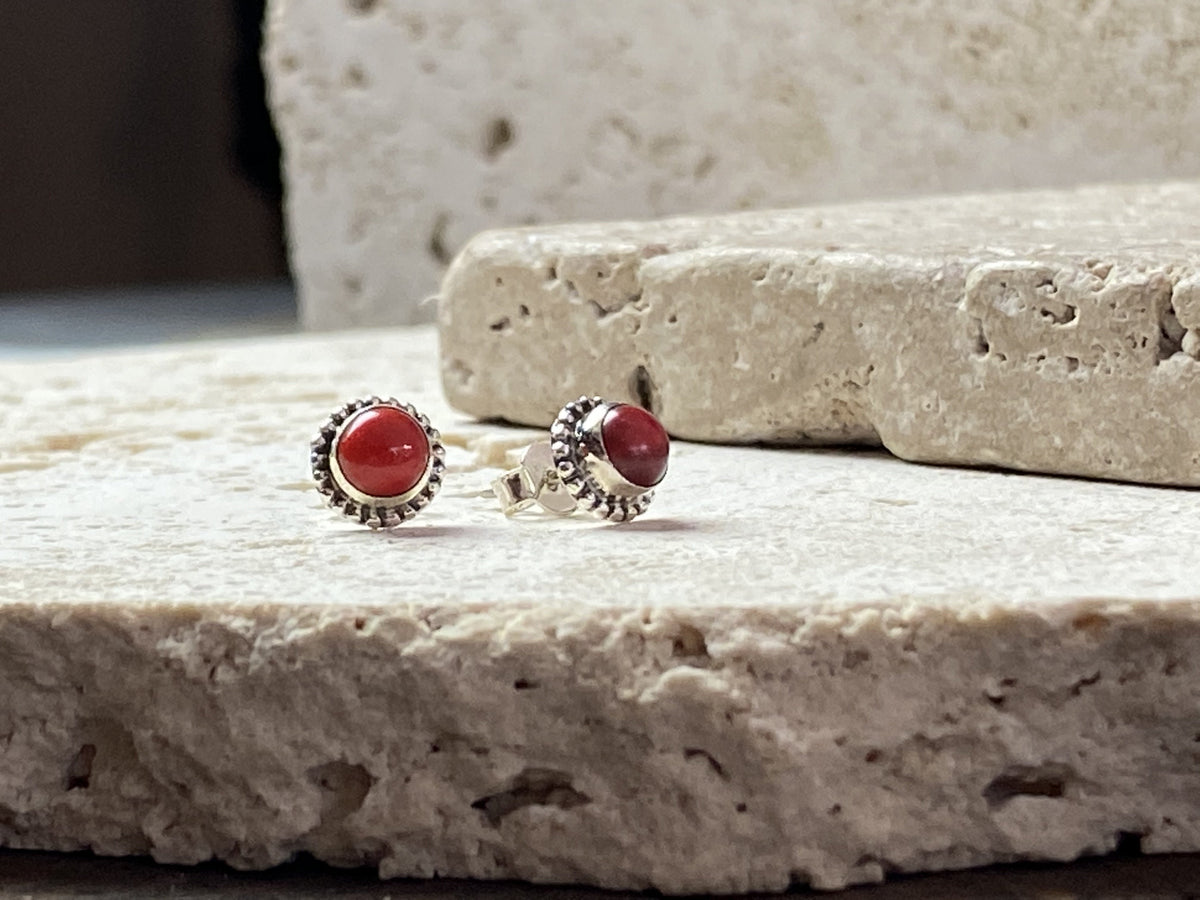 Simple and elegant, these small red coral earring studs are hand made from sterling silver and set with bamboo coral cabochons