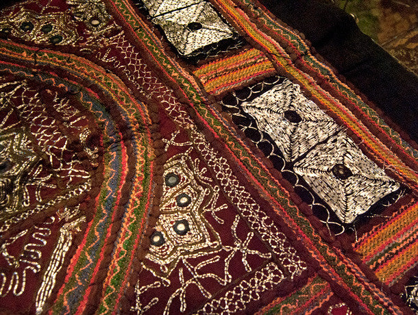 Traditional Sind Desert tribal textile, made up of many panels of embroidery with heavy silver thread and small mirrors to produce a stunningly cohesive effect that is traditionally called zari work or zari embroidery. Full lined at the back with red cotton and bordered with black cotton. From northwest India. Approximately 50-60 years old.  Measurements: 173 cm x 134 cm