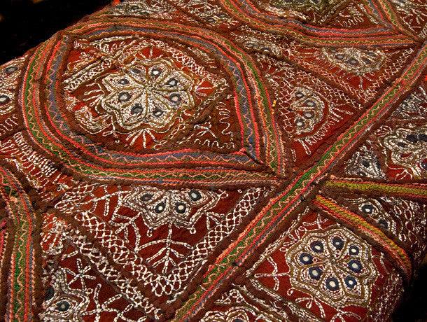 Traditional Sind Desert tribal textile, made up of many panels of embroidery with heavy silver thread and small mirrors to produce a stunningly cohesive effect that is traditionally called zari work or zari embroidery. Full lined at the back with red cotton and bordered with black cotton. From northwest India. Approximately 50-60 years old.  Measurements: 173 cm x 134 cm