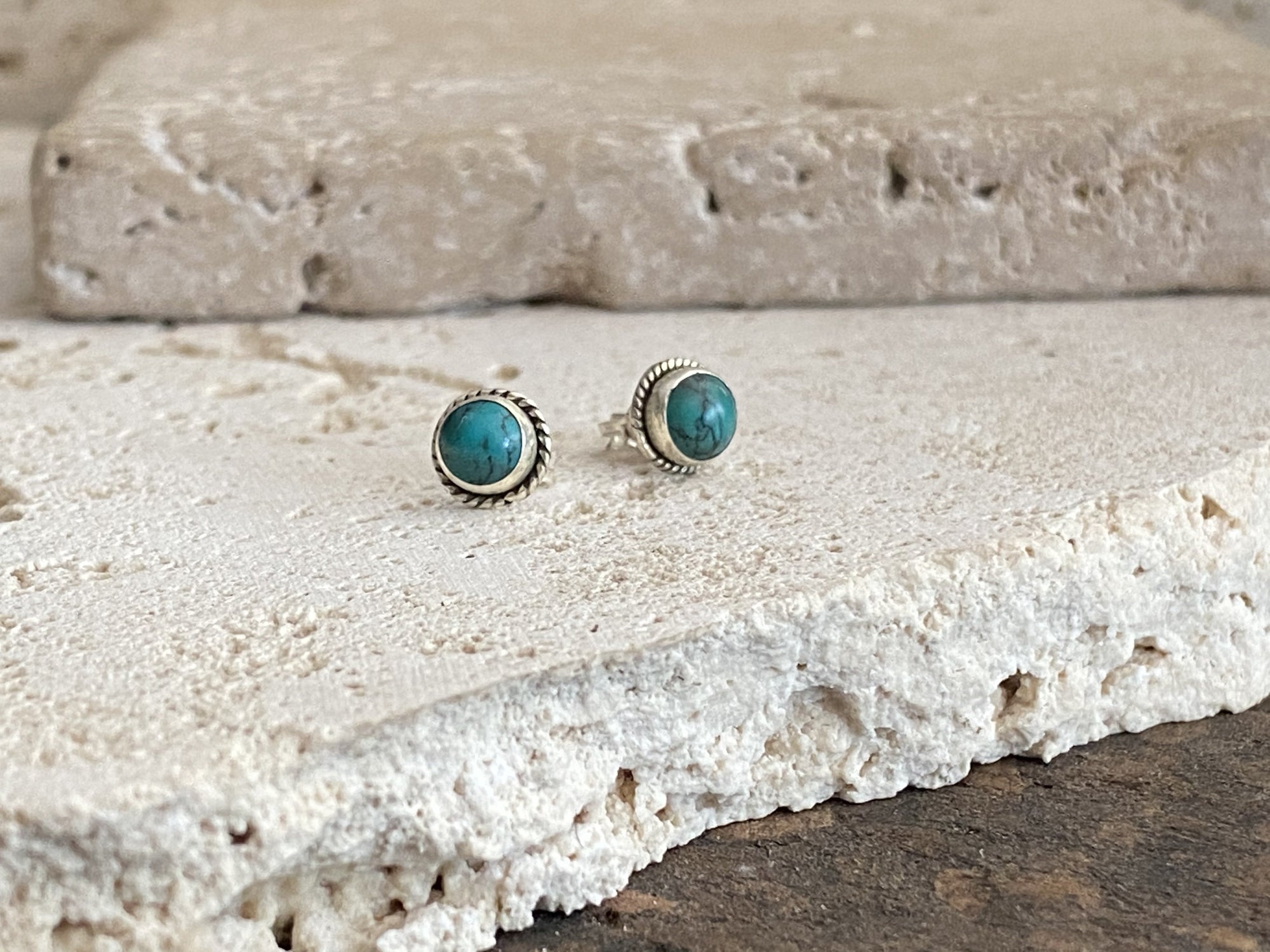 Small natural turquoise earring studs are hand made from sterling silver and set with turquoise cabochons. A unisex earring